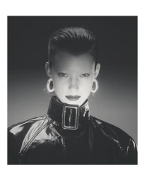 Model Dana Smith wearing a black high-collar jacket and hoop earrings in a portrait by photographer Casper Sejersen.