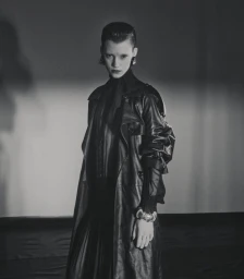 Model Dana Smith wearing a black leather trench coat in a dramatic monochrome fashion portrait for D Repubblica.