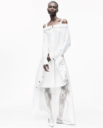 Model Debra Shaw wearing a white off-the-shoulder dress in a 212 Magazine cover story