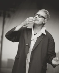Jeff Goldblum wearing dark glasses and a coat in a black and white portrait for U Repubblica photographed by Michael Bailey Gates.