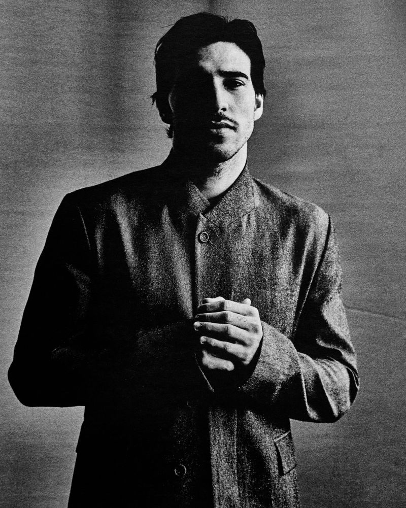 Portrait of athlete Sandro Tonali wearing a buttoned jacket in a high-contrast monochrome editorial photograph