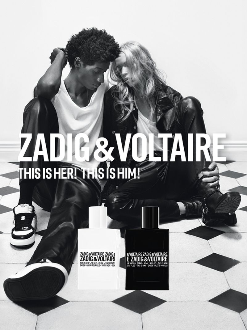 Black and white shot of a stylish couple, posing with Zadig & Voltaire perfume bottles against a tile floor and minimal backdrop.