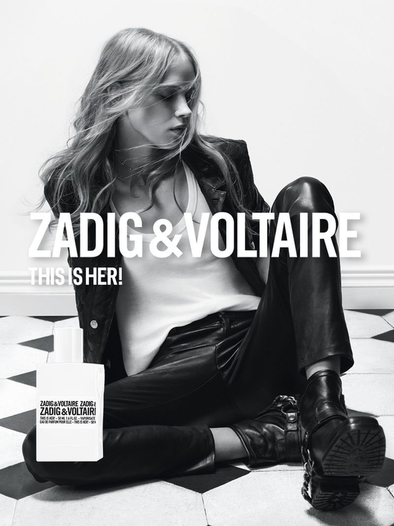 Blonde model in leather jacket and pants sits on checkered floor in black and white perfume ad for Zadig & Voltaire 'This is Her!'