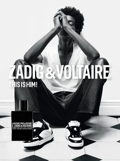 Model Louis Dicko seated on a checkered floor with hands clasped above his head for Zadig and Voltaire
