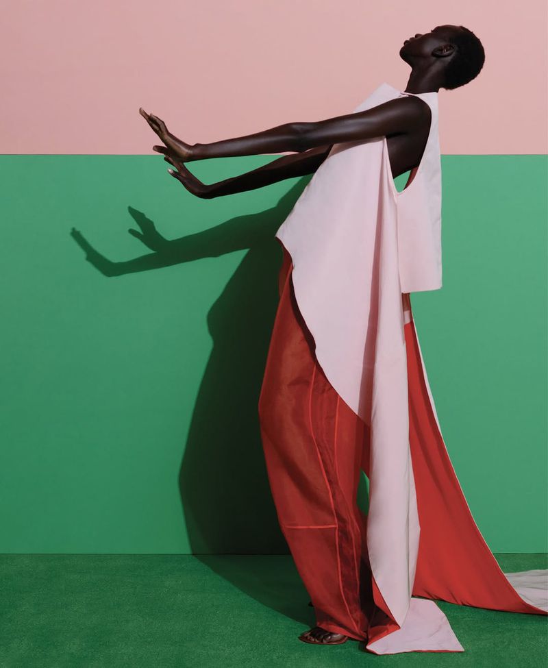 Model Rejoice Chuol leaning back dramatically against a split pink and green wall for WSJ High Contrast project photographed by Viviane Sassen.