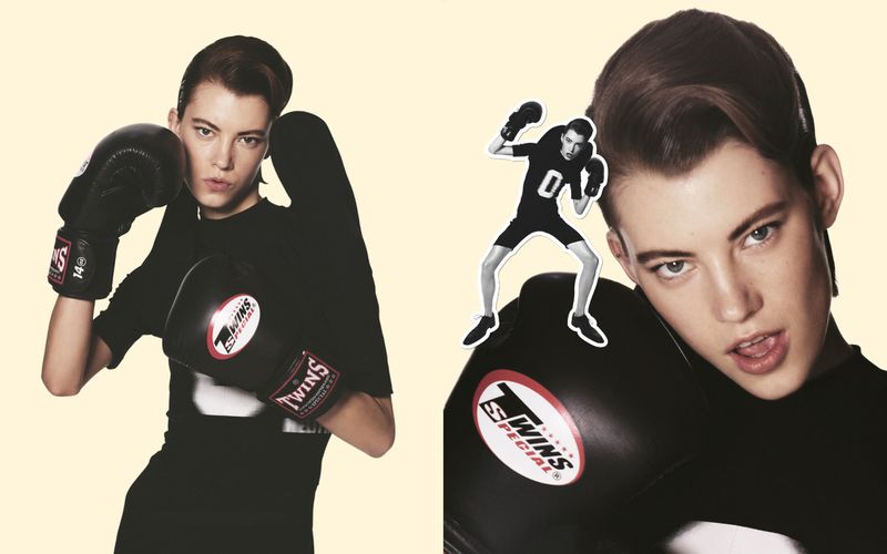 Female fighter in black shirt and boxing gloves poses near a collage of herself boxing against a split cream-colored background.