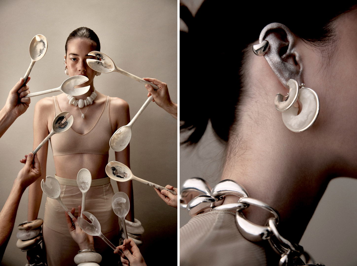 Woman poses with large spoons and jewelry in a conceptual fashion shot against a neutral backdrop, showing a nude bra and bracelets.