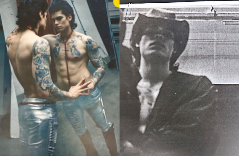 Tattooed male fashion model poses in front of a mirror wearing silver metallic pants, contrasted with a man in a cowboy hat.