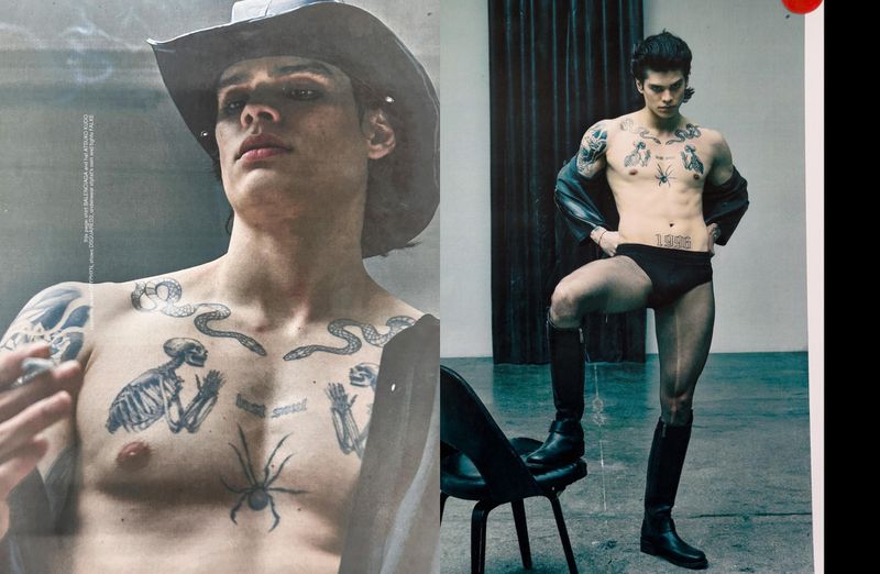 Tattooed man in a cowboy hat and tall boots posing in an editorial spread for The Face Magazine.