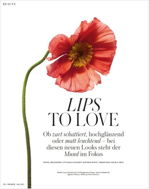 A vibrant red poppy flower with a long green stem against a clean white background, featuring editorial typography.