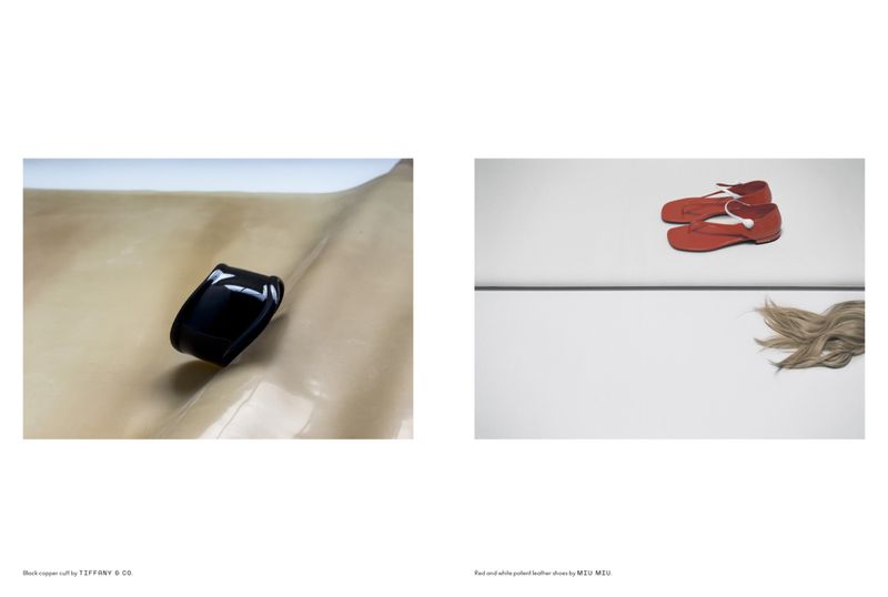 Fashion still life: black cuff bracelet on tan surface, red Mary Jane shoes with white trim, and blond hair on white surface.