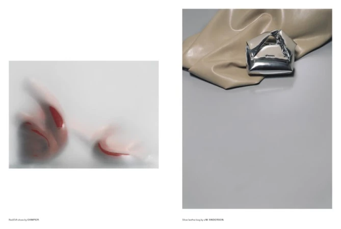 Fashion product shot featuring red EVA shoes behind frosted glass and a silver leather bag on a gray and beige surface.
