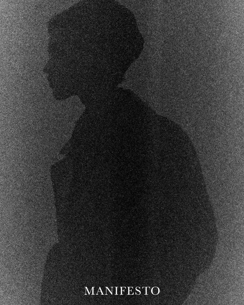 Silhouette of a person with a head covering against a textured dark gray background with the word 'MANIFESTO' in white text.