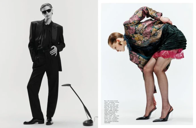 Fashion editorial shot of two models wearing designer clothing and high heels in a bright, minimalist studio setting with a modern lamp.