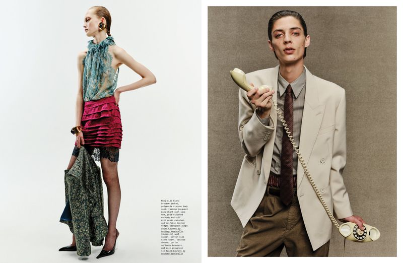 Editorial shot of two people: a woman in a ruffled top and skirt, and another person in a tan suit holding a vintage telephone.