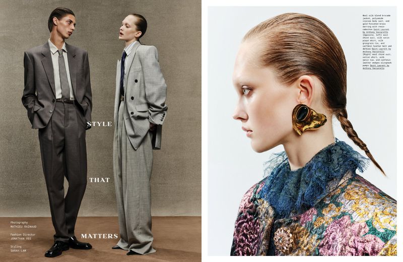Two models standing in structured grey suits beside a close-up portrait of a model wearing an ornate patterned jacket and sculptural gold earring.