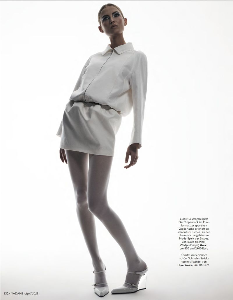Fashion shot of a fair-skinned adult female fashion model in a white mini dress and wedge heels on a white background in studio lighting.
