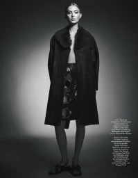 Model Emma StSalhammar in a dark fur-collared coat against a seamless background for Madame Germany.