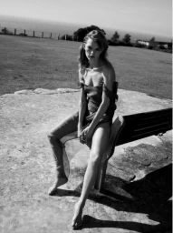 Model Daphne Maas seated on a wooden bench outdoors in a black and white fashion editorial for Lobster Magazine.