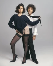 Selena Gomez and Benny Blanco posing against a grey backdrop for Interview Magazine photographed by Roe Ethridge.
