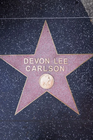 Close-up overhead view of the Devon Lee Carlson star on the Hollywood Walk of Fame embedded in dark terrazzo