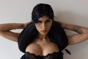 Portrait of Mia Khalifa wearing a black lace corset and rhinestone veil for Autre Magazine, photographed by Nick Sethi.
