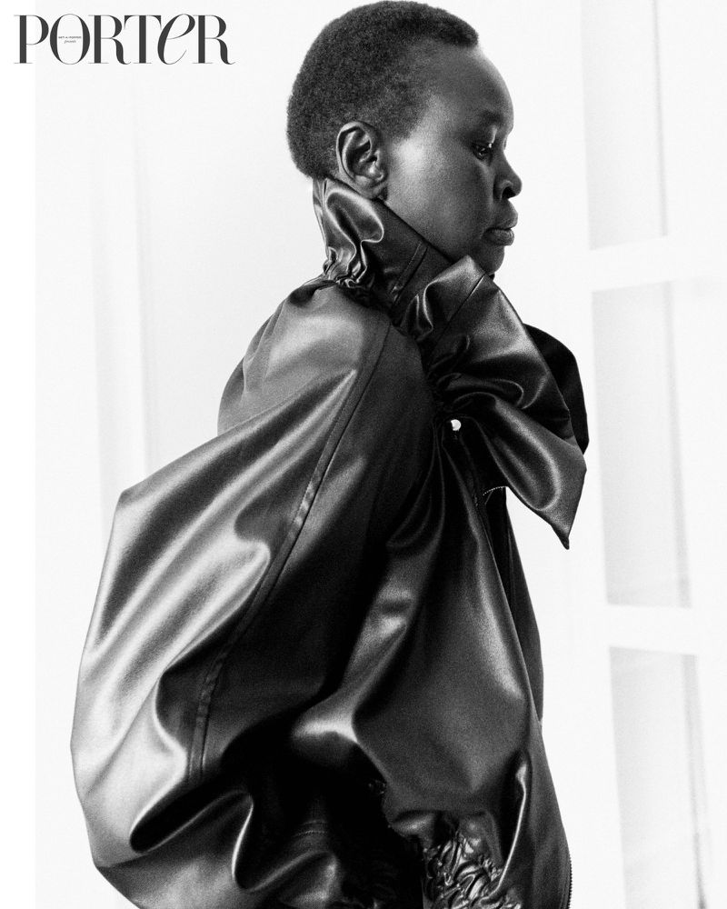Black and white portrait of a Black woman wearing a high-necked, large-sleeved dress with the magazine 'Porter' visible in the top left.