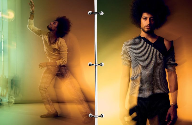 Two young adult male models with afros pose indoors in a split image; one is blurred in motion, the other is standing still.