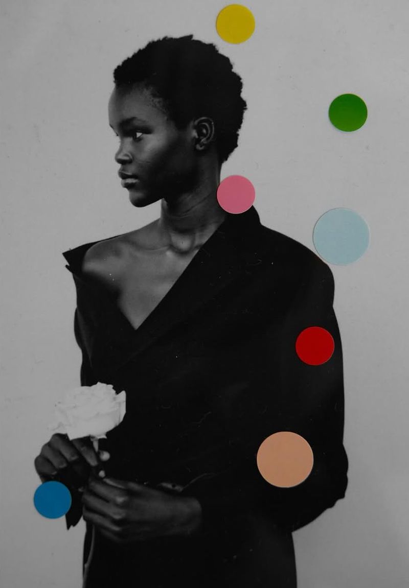 Black and white photograph of a young African woman in a black coat holding a white rose, adorned with colorful circle stickers.