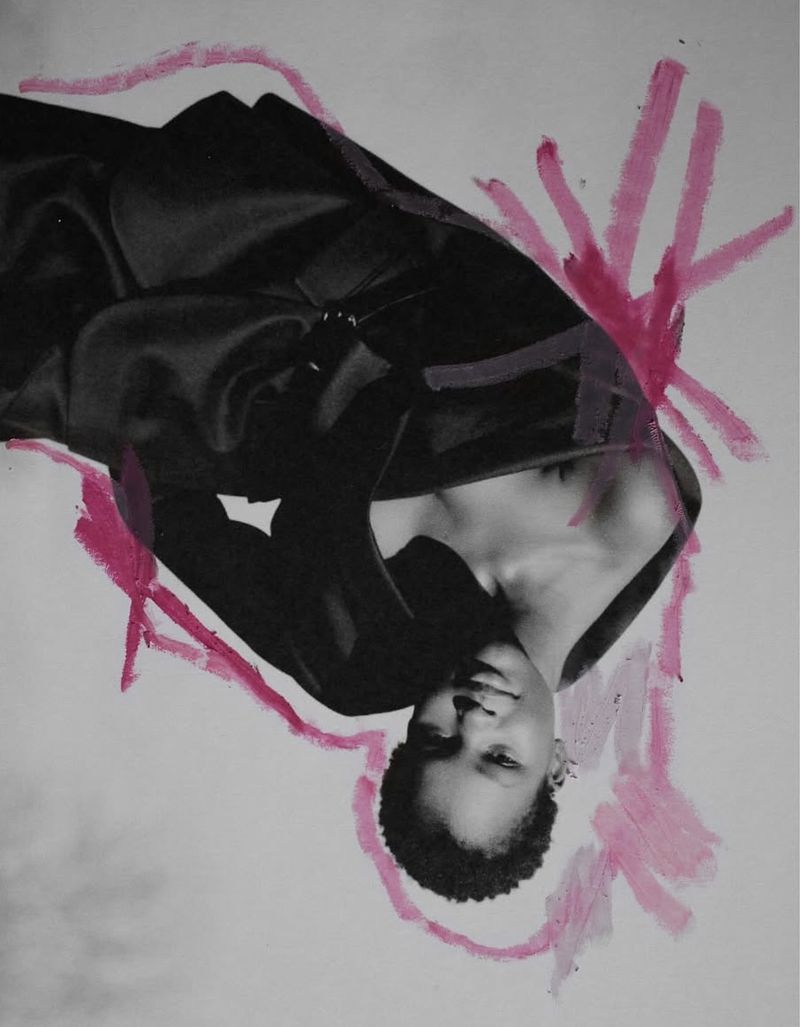 Monochrome portrait of a black woman with dark clothing, enhanced with bright pink brushstrokes around the subject in an artistic style.