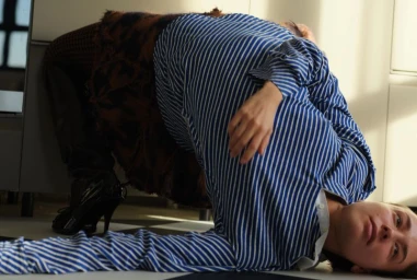 Model in a blue striped top and skirt bending backwards on a checkered floor for a PUBLIC Editions project.