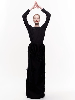 Model Sterre Haket in a long black dress with arms raised for Puss Puss Magazine editorial, photographed by Jonathan Arundel