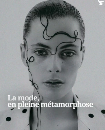 Monochromatic close-up portrait of a woman with slicked-back hair, graphic design on her face, wearing a polka dot pattern jacket.