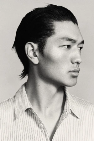 Profile portrait of an East Asian male model with slicked-back dark hair wearing a striped shirt against a neutral background.