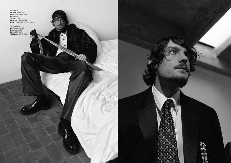 Black and white diptych of a stylish man in a fur jacket on a bed and a tailored suit with a tie and necklace, indoors.