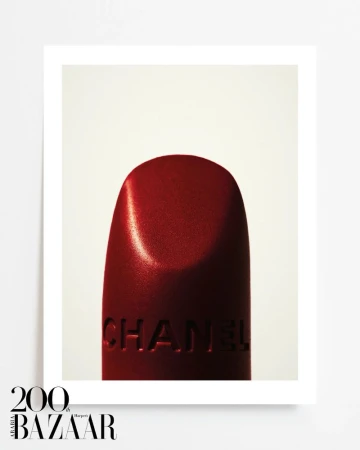 Close-up of a dark red Chanel lipstick bullet against a clean white background, photographed for Harper's Bazaar Arabia.