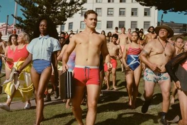 Group of diverse people in swimwear walking outdoors toward the camera for a Speedo campaign