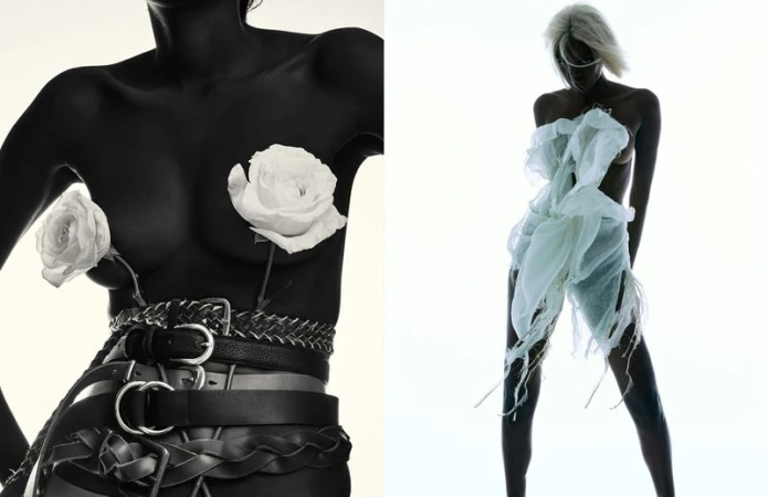 Two women strike poses in a studio setting; one wears belts and roses, while the other is adorned with sheer white fabric.