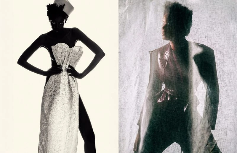 Fashion shot of a dark-skinned woman in a corset dress with a hat, and another woman behind a translucent fabric in the background.