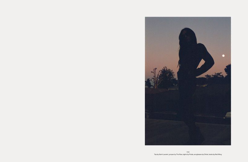 Silhouette of a woman standing outdoors against a dusk sky with a pale moon for Middle Plane Magazine Back to Zero
