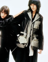 Two models wearing textured dark jackets against a seamless white studio background for the Parade project by Crosscurrent.