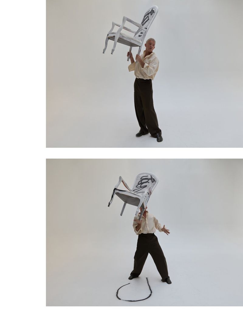 Man balances painted gray armchair overhead in photo studio with white backdrop; another photo below shows similar pose.