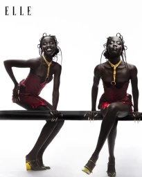 Two black female models posing in red corsets and gold necklaces against a white background for Elle Thailand