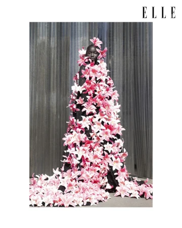 Model wearing a black gown completely covered in pink lilies for an Elle Thailand editorial photographed by Petros Kouiouris