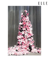 Model wearing a black gown completely covered in pink lilies for an Elle Thailand editorial photographed by Petros Kouiouris