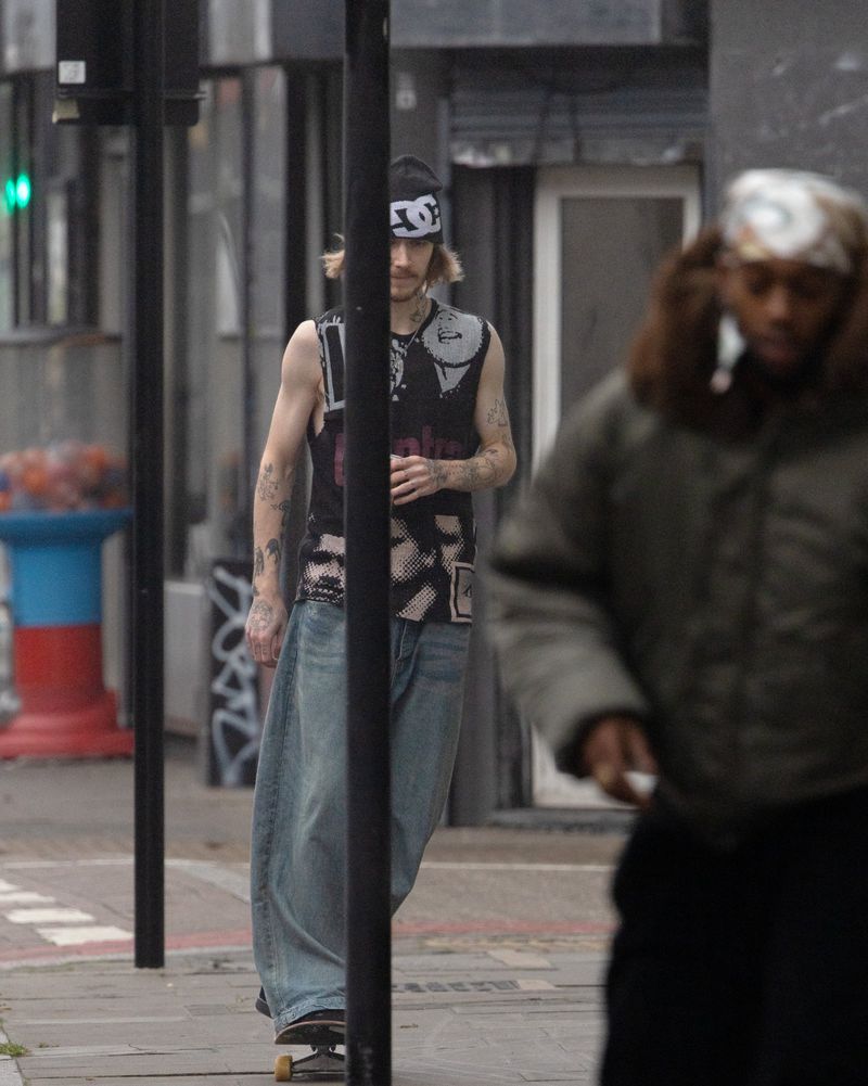 Skater in a graphic sleeveless top and beanie on a sidewalk, captured for i-D Magazine by photographer Winter Vandenbrink.