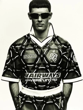 Model Connor Newall wearing patterned athletic top and sunglasses against a light background for 10 Men Magazine