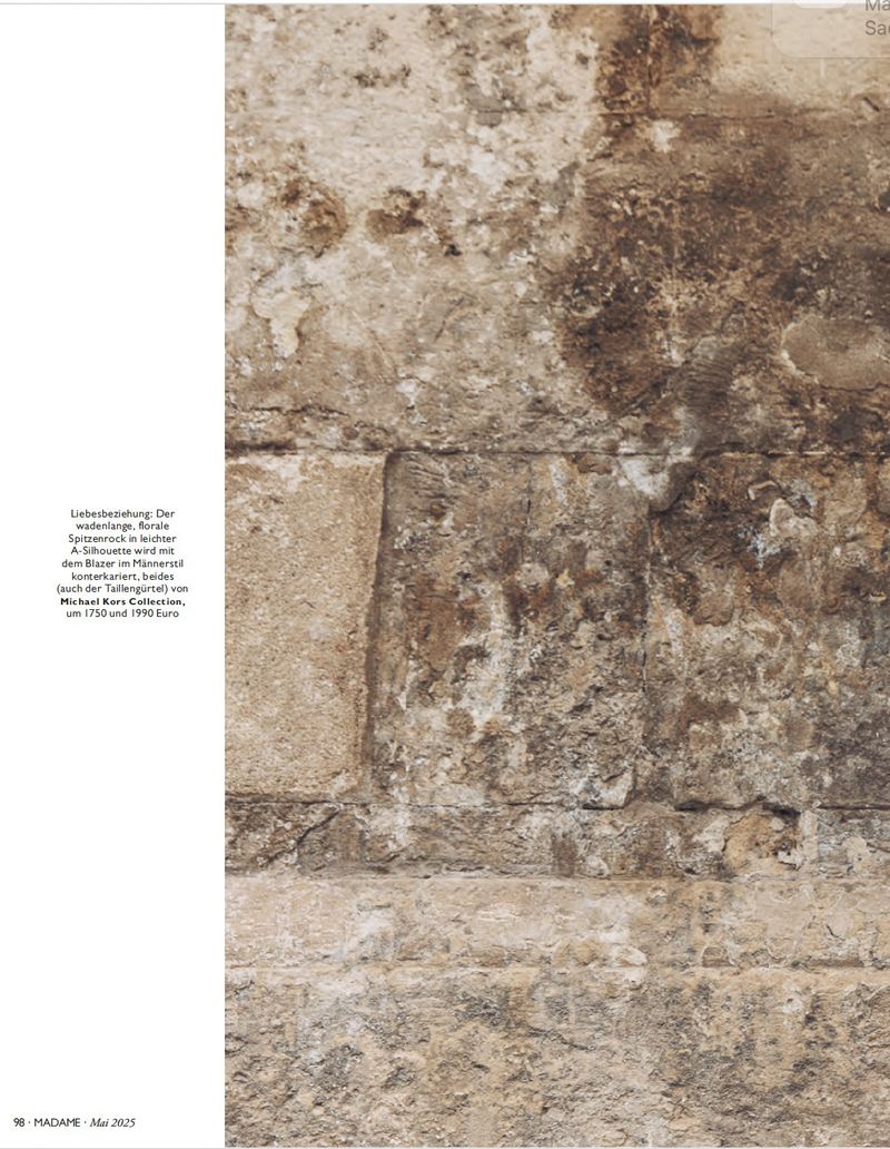 Close-up of a weathered stone wall with textured surfaces in light brown and beige tones, revealing age and natural elements.