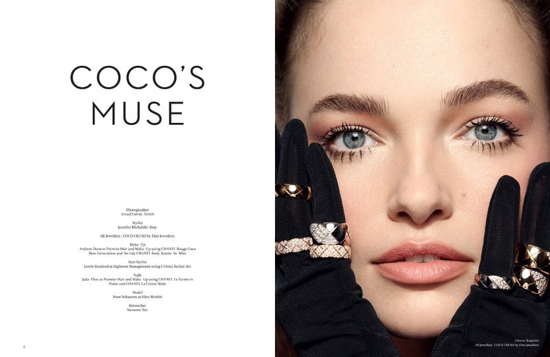 Close-up of a woman with light eyes and black gloves adorned with diamond rings, showcasing fine jewelry in a high-fashion editorial setting.