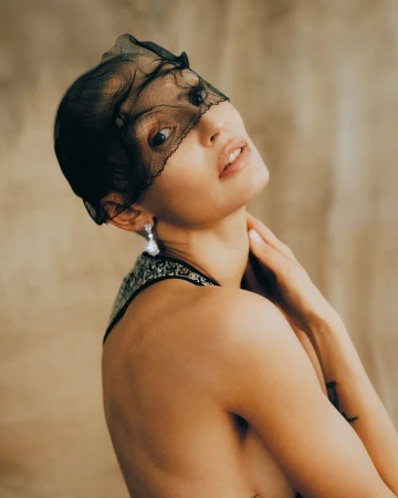 Model Bianca Balti wearing a black mesh face veil and diamond earring for Vanity Fair Italia editorial